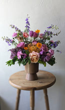 Load image into Gallery viewer, Modern flower arrangement with seasonal flowers. Arranged in a Mauve ceramic footed vase. Available for local flower delivery.